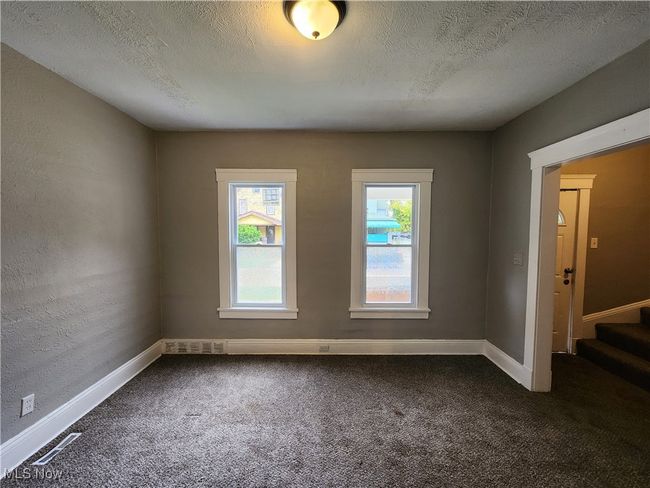 Empty room with a textured ceiling and carpet floors | Image 6