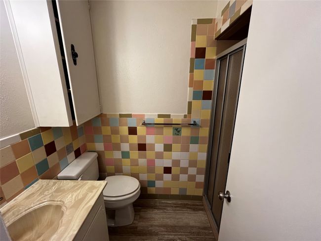 Across from utility, this efficient secondary bathroom also features a walk-in shower. | Image 23
