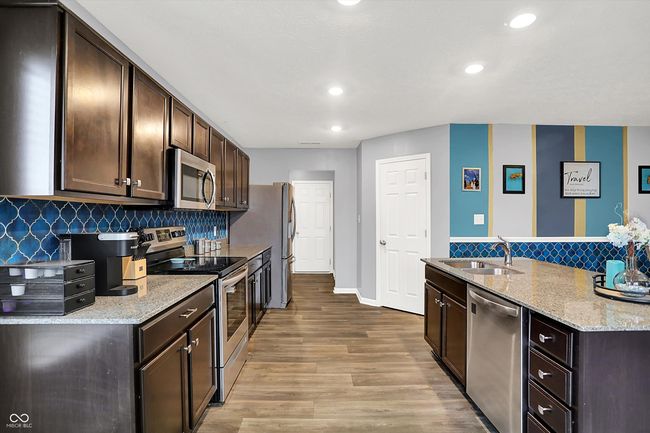 Large kitchen with stainless steel appliances, plenty of cabinets and counter space AND a pantry. | Image 9