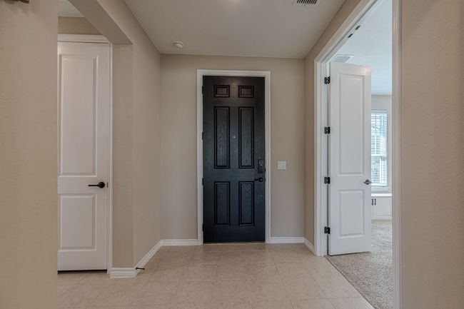 Entrance foyer featuring light tile patterned floors and light carpet | Image 5