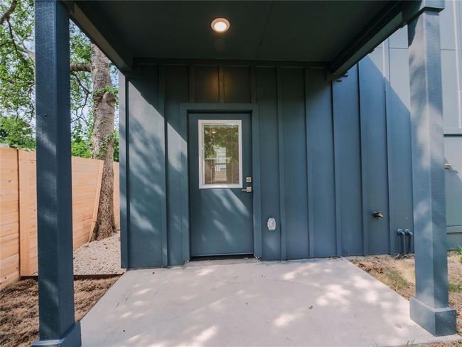 Doorway to property with board and batten siding and a patio | Image 22