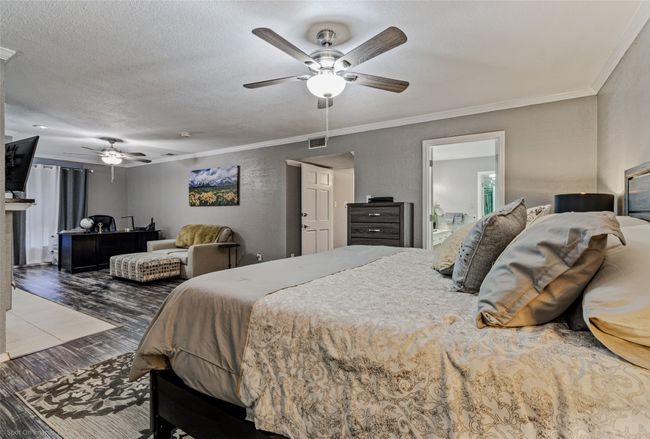 Primary suite with sitting area, fireplace and private entrance. | Image 16