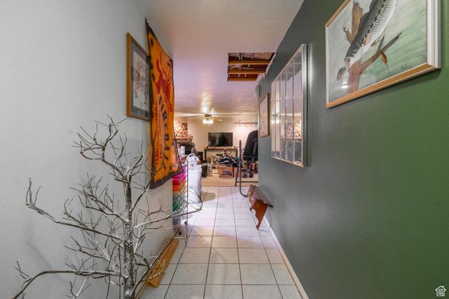 Hall featuring light tile patterned floors and baseboards | Image 45
