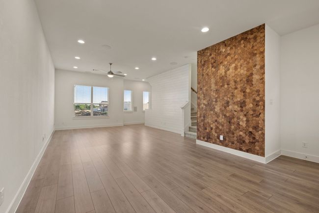 Unfurnished room with baseboards, recessed lighting, a ceiling fan, wood finished floors, and stairs | Image 16