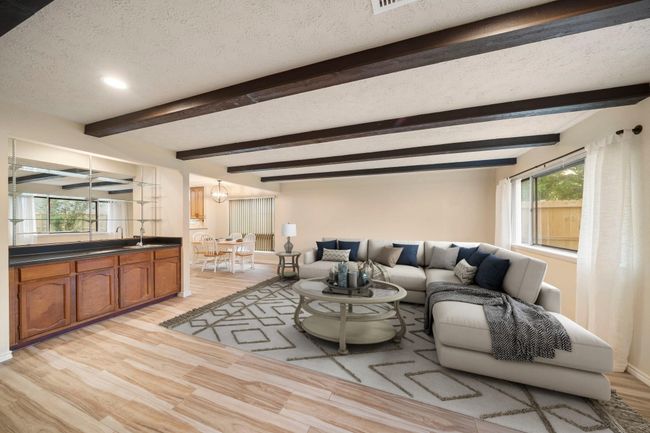Oversized windows provide abundant natural light, while the open layout connects seamlessly to the breakfast area and kitchen for optimal flow. This photo has been virtually staged. | Image 17