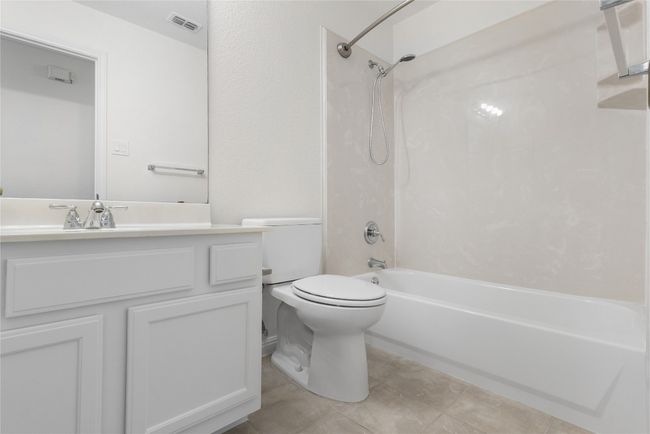 Bathroom featuring bathing tub / shower combination, vanity, and tile patterned floors | Image 20
