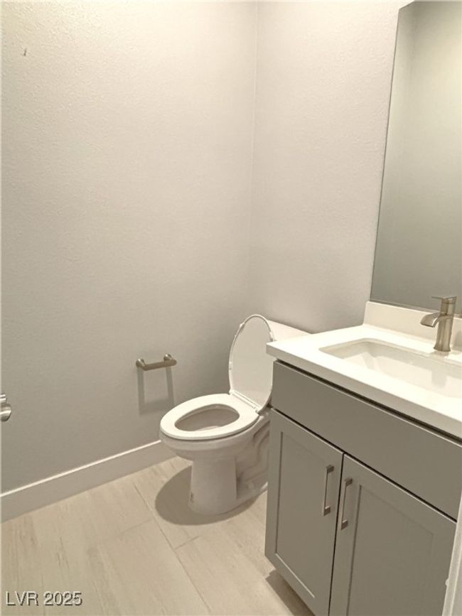 Bathroom with toilet, vanity, and baseboards | Image 19