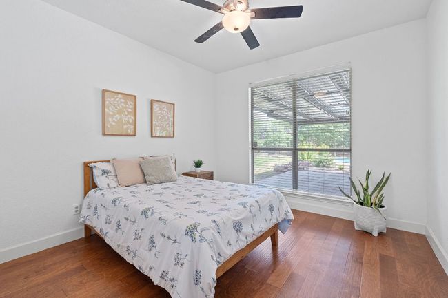 Bedroom with wood finished floors and a ceiling fan | Image 25
