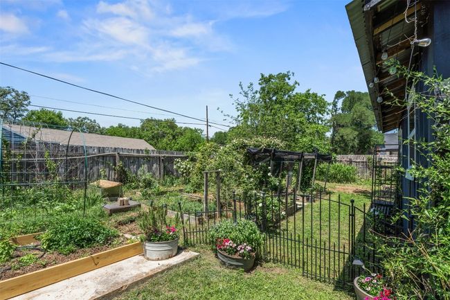 Fenced backyard with a garden | Image 36