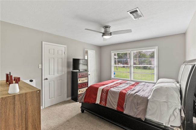 Bedroom featuring light carpet and ceiling fan | Image 24