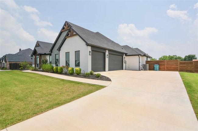 View of front of house featuring a front yard and a garage | Image 3