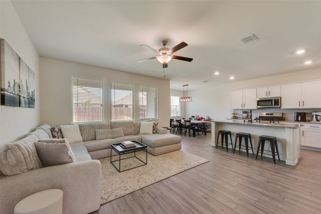 Living area featuring a ceiling fan, light wood-type flooring, and recessed lighting | Image 4