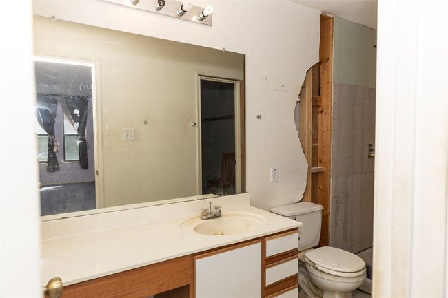 Bathroom featuring vanity and toilet | Image 9