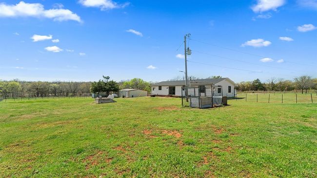 View of yard featuring fence and an outbuilding | Image 20