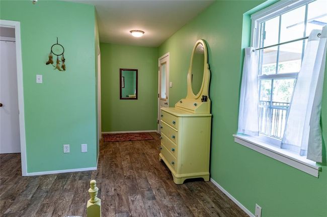 Upstairs bedroom (three of three) with door to balcony to the right. | Image 25