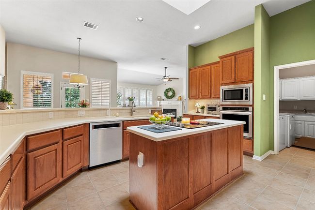 Designed with flow in mind, the kitchen opens into the living and breakfast areas, making the space feel expansive and ideal for both cozy dinners and lively get-togethers | Image 16