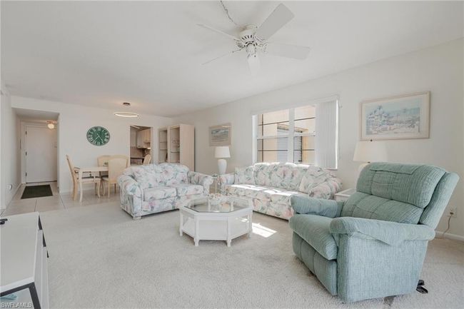 Living room with ceiling fan and light tile flooring | Image 8