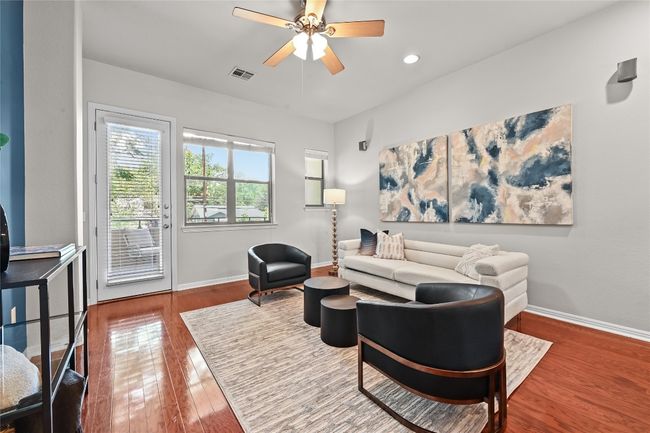 Second floor living area with door to covered patio | Image 7