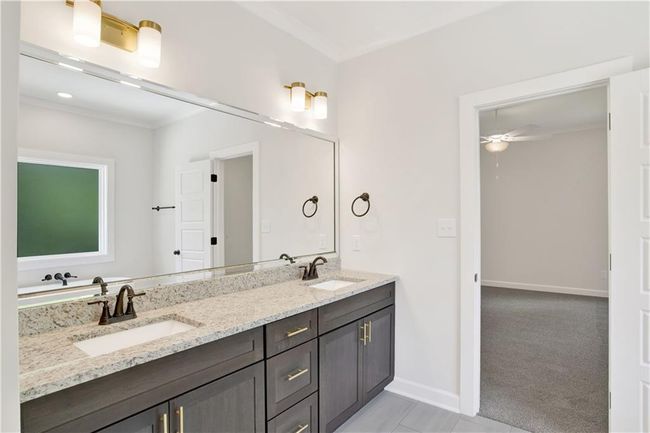 Bathroom featuring a sink, crown molding, a ceiling fan, and double vanity | Image 28