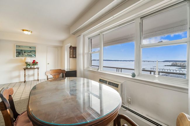 Dining area next to picture window with broad river views | Image 16