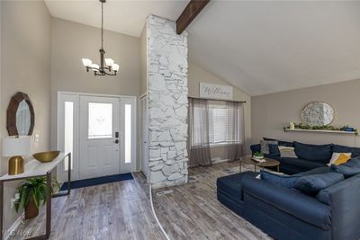 Foyer with high vaulted ceiling, hardwood / wood-style flooring, beamed ceiling, and an inviting chandelier | Image 2