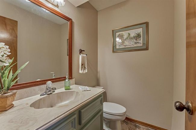 Situated on the main floor with the kitchen and living areas, the half bath provides easy access for guests without disturbing the private spaces of the home. | Image 25