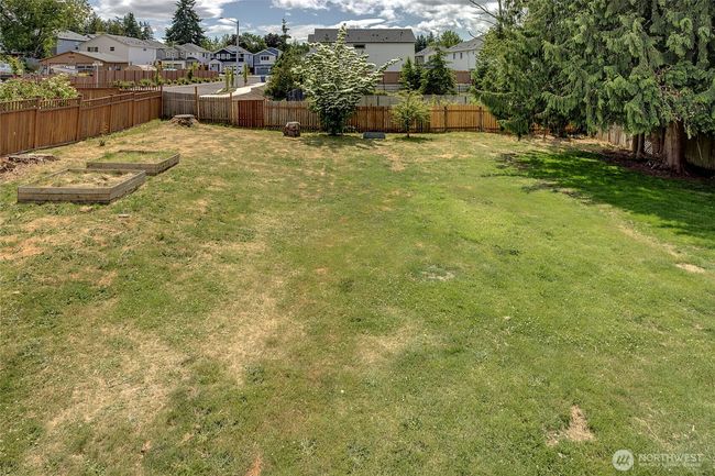 Spacious backyard with garden beds. | Image 22