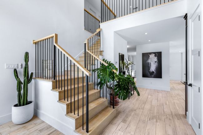 Staircase with wood finished floors, a high ceiling, and recessed lighting- wide entry way | Image 5