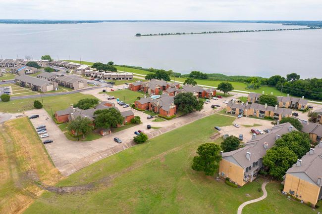 Aerial view of residential area with a large body of water | Image 8