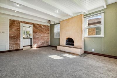 Sunny living room with fireplace & new carpeting | Image 2