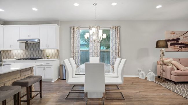 Dining room with recessed lighting, wood finished floors, and a chandelier | Image 14