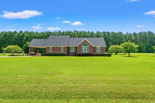 Single story home featuring a front yard and a carport | Image 28