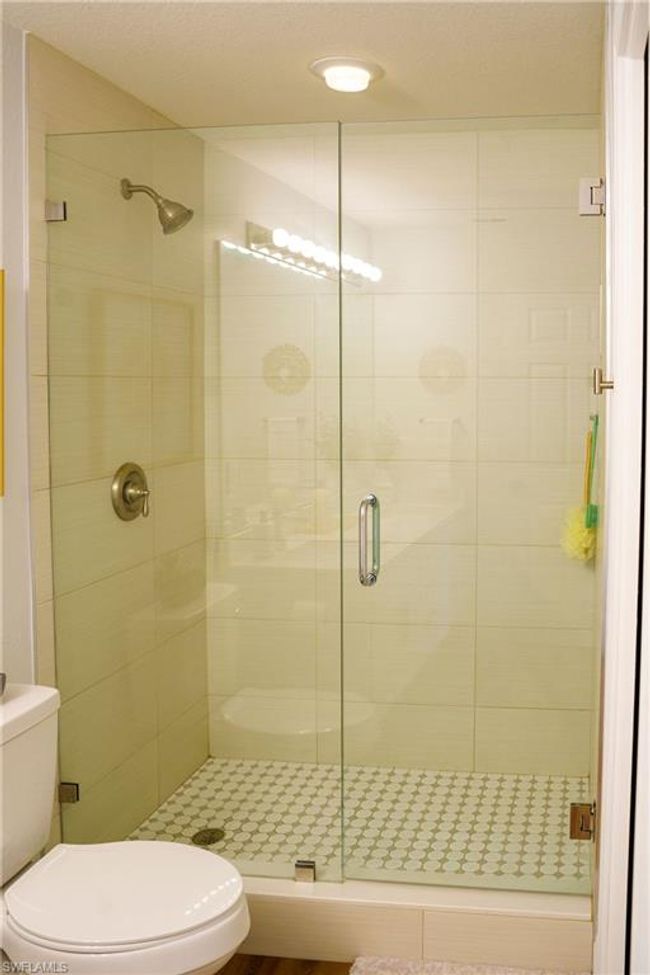 Bathroom featuring a shower stall and toilet | Image 14