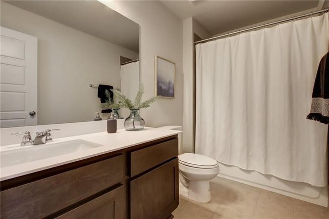 Bathroom with vanity, tile patterned floors, and shower / tub combo | Image 30