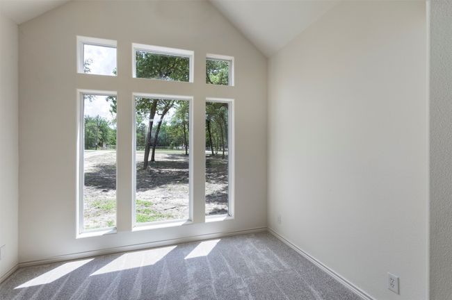 Carpeted empty room with high vaulted ceiling and baseboards | Image 23