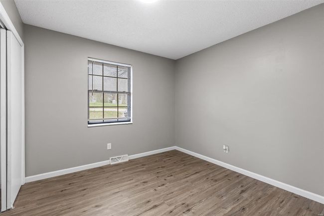 Spare room featuring baseboards, a textured ceiling, and wood finished floors | Image 17
