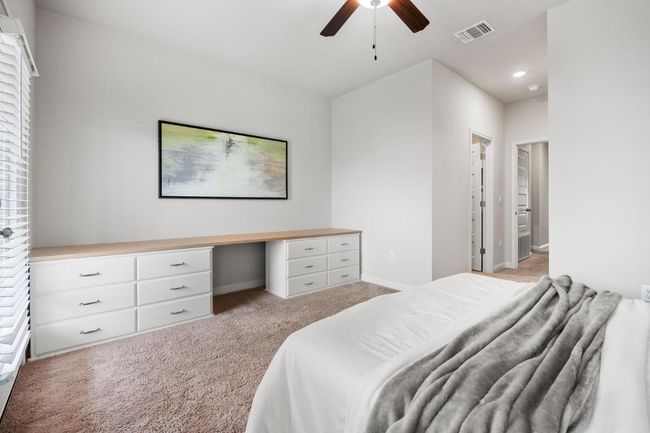 Bedroom with light colored carpet, recessed lighting, ceiling fan, and baseboards | Image 9