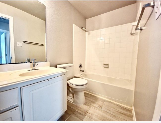 Bathroom with vanity and bathing tub / shower combination | Image 14