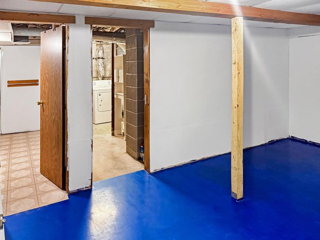 The landing in the basement leads to the bathroom, laundry room, and 4th bedroom. | Image 25