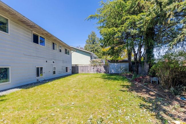 Fenced backyard featuring an outbuilding | Image 21
