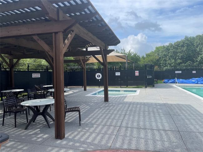 Community pool with a patio area | Image 4