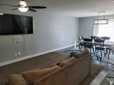 Living room featuring hardwood / wood-style flooring and ceiling fan | Image 2