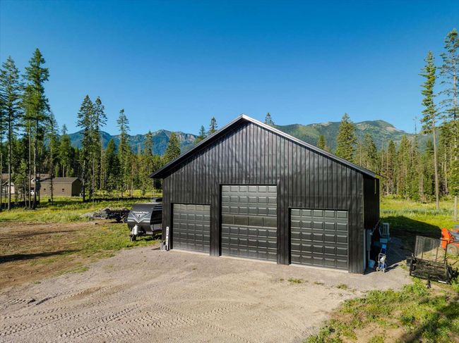 Detached garage featuring a mountain view and a view of trees | Image 76