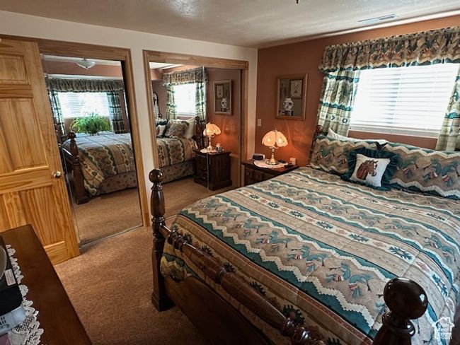 Bedroom featuring light carpet and visible vents | Image 13