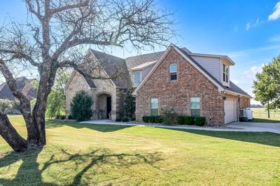 View of front of house featuring a garage and a front lawn | Image 1