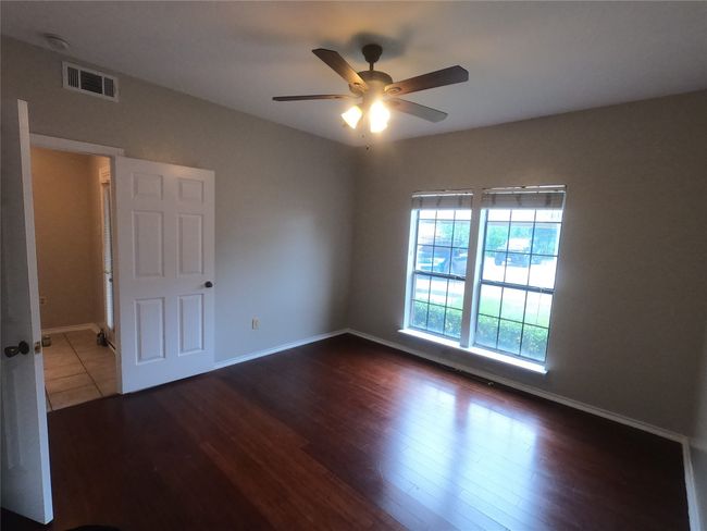 Unfurnished room with ceiling fan, baseboards, and wood finished floors | Image 4
