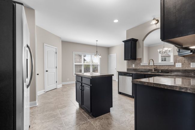 Another View of the Kitchen Looking into the Eat-In Area! There is an Arched Window Looking into the Formal Dining Room and a Walk-in Pantry!! | Image 8