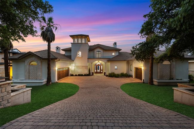 Mediterranean / spanish home with an attached garage, decorative driveway, stucco siding, and a front lawn | Image 29