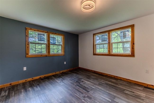 Empty room with plenty of natural light, baseboards, and dark wood finished floors | Image 33