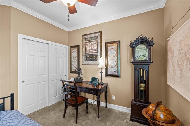 Home office featuring carpet flooring, a ceiling fan, ornamental molding, and baseboards | Image 32